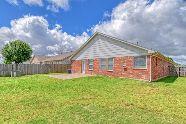 back of house with a patio area, brick siding, and central AC unit
