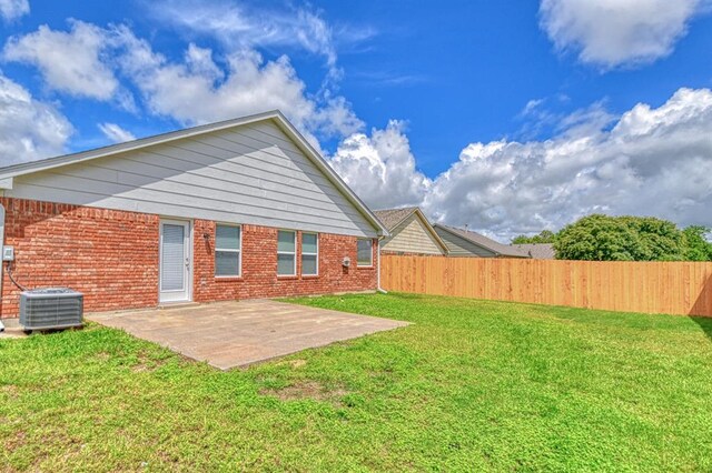 back of house with cooling unit, a patio area, and brick siding