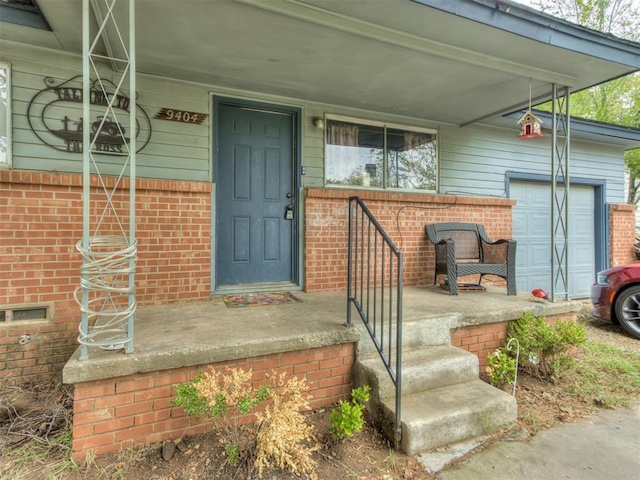 property entrance featuring a porch and a garage