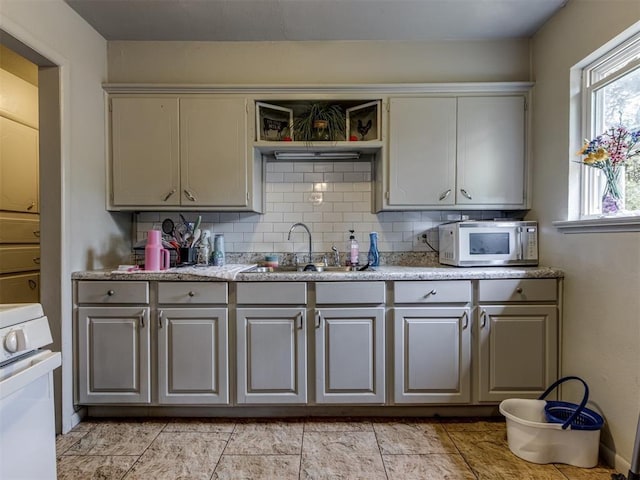 kitchen with sink, backsplash, and range