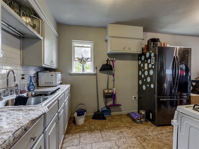 kitchen with white appliances, sink, and decorative backsplash