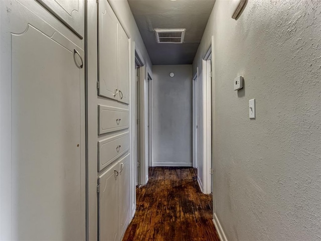 corridor with dark hardwood / wood-style floors