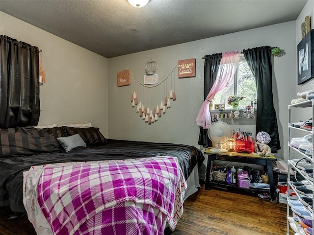 bedroom featuring hardwood / wood-style flooring and a textured ceiling