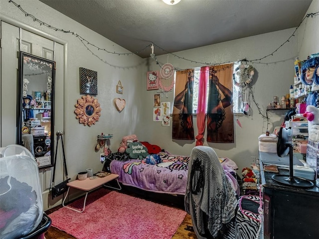 bedroom with lofted ceiling and wood-type flooring