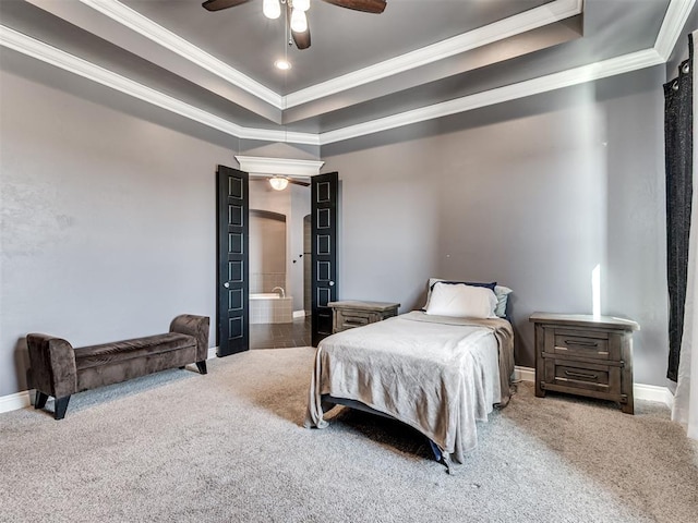 carpeted bedroom featuring ceiling fan, ensuite bath, ornamental molding, and a raised ceiling