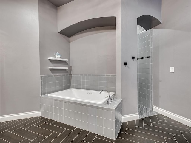 bathroom featuring shower with separate bathtub