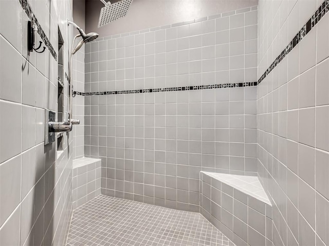 bathroom with tiled shower