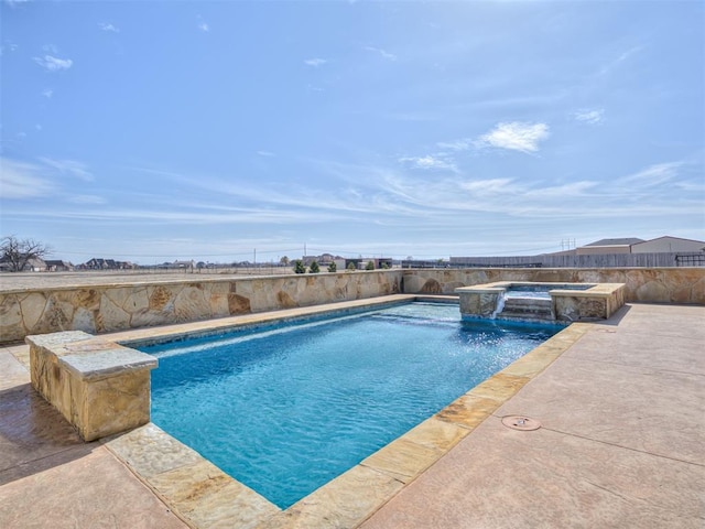 view of pool with an in ground hot tub