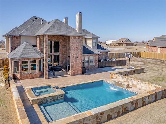 view of swimming pool with area for grilling, an in ground hot tub, pool water feature, a gazebo, and a patio area