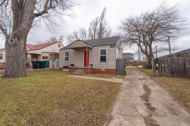 bungalow-style house with a front lawn