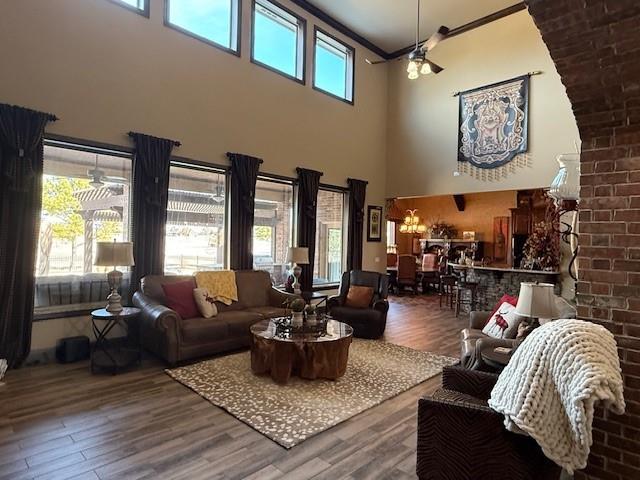 living room featuring ornamental molding and wood-type flooring