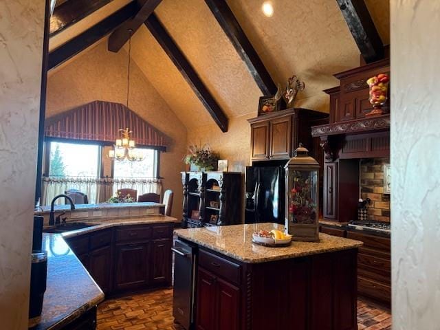 kitchen featuring sink, dark brown cabinets, a center island, a notable chandelier, and black refrigerator with ice dispenser