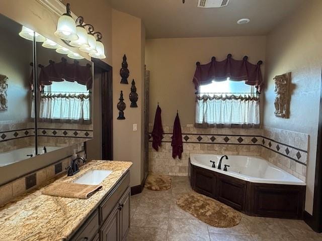 bathroom with vanity, a bath, a wealth of natural light, and tile patterned floors