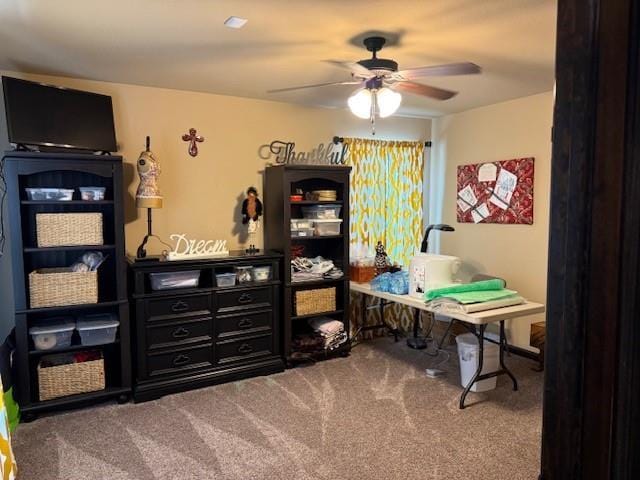 interior space featuring ceiling fan and carpet flooring