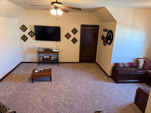 living room with vaulted ceiling, light colored carpet, and ceiling fan