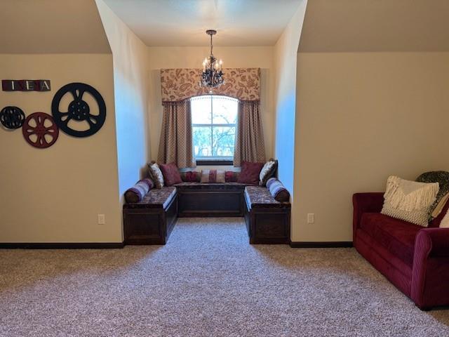 sitting room with carpet flooring and a chandelier