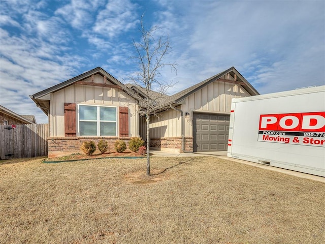 view of front of property with a garage, brick siding, board and batten siding, and fence