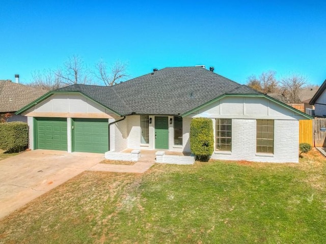 view of front of house featuring roof with shingles, brick siding, a front yard, a garage, and driveway