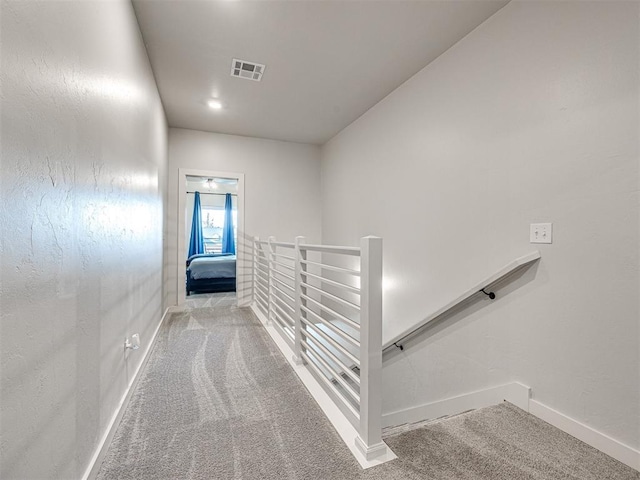 hallway with light colored carpet