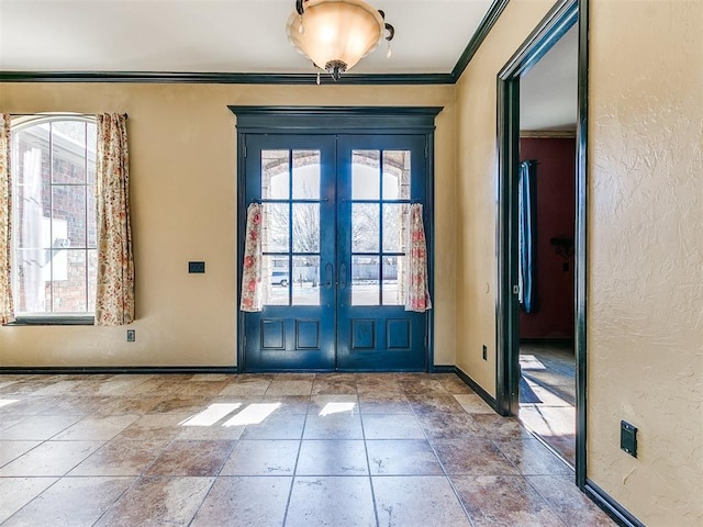 doorway featuring crown molding, plenty of natural light, and french doors