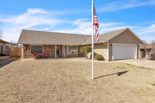 ranch-style house with a garage, concrete driveway, fence, and a shingled roof