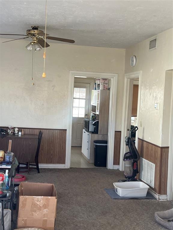 506 N Broadway St, Marlow, OK 73055 - interior space featuring ceiling fan, wooden walls, and a textured ceiling
