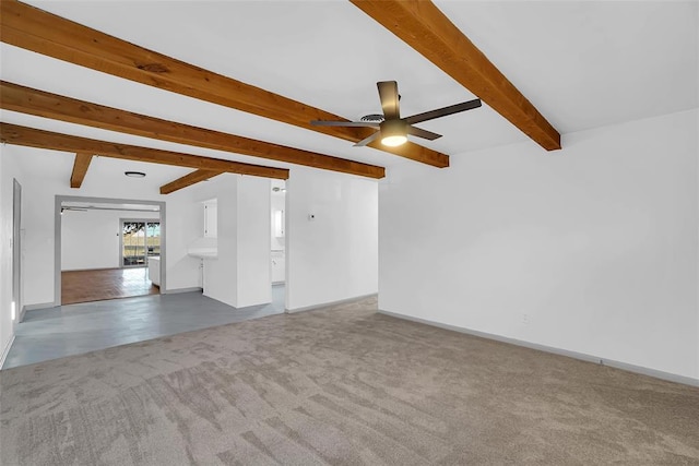 unfurnished living room featuring beamed ceiling, ceiling fan, and carpet