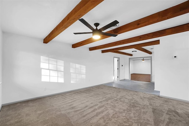 unfurnished living room with ceiling fan, beam ceiling, and light colored carpet