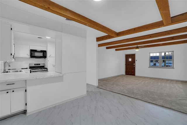 interior space featuring sink, light colored carpet, and beam ceiling