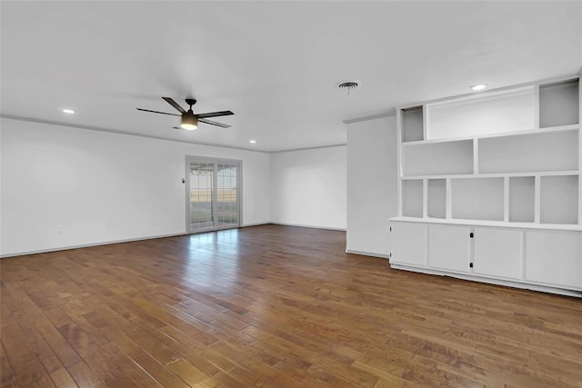 unfurnished living room featuring dark wood-type flooring and ceiling fan