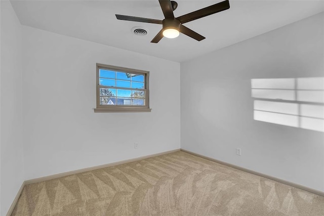 spare room with carpet and ceiling fan