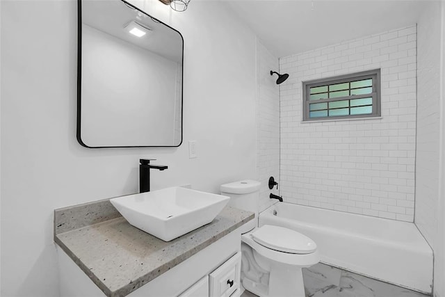 full bathroom featuring vanity, tiled shower / bath combo, and toilet