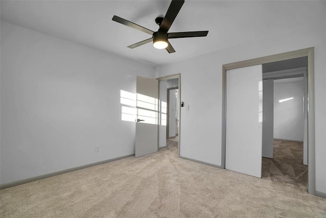 unfurnished bedroom featuring ceiling fan and light carpet