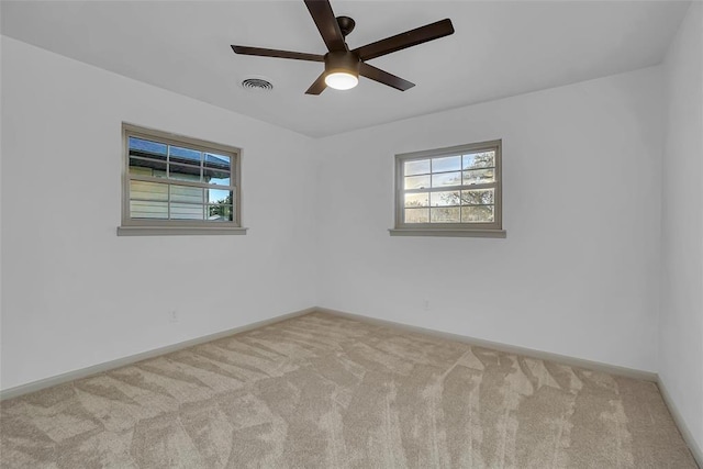 empty room featuring light colored carpet and ceiling fan