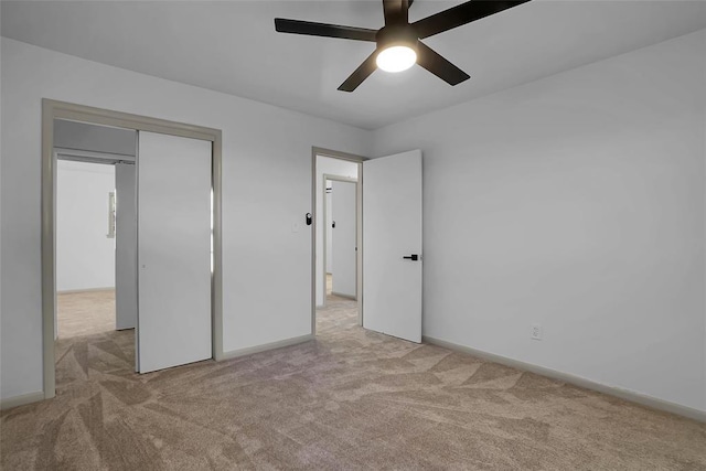 unfurnished bedroom with ceiling fan and light colored carpet