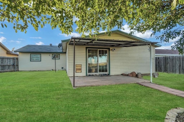 back of property featuring a patio and a yard