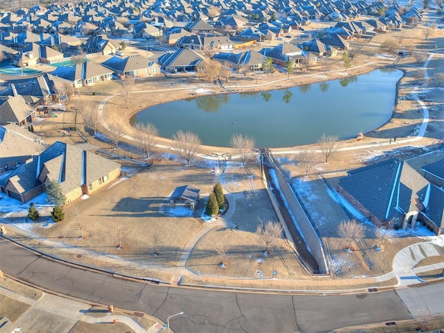 drone / aerial view with a residential view and a water view