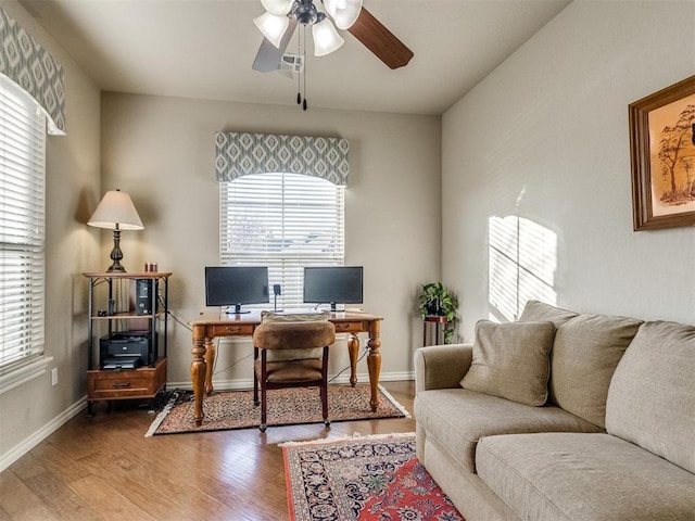 office with a ceiling fan, baseboards, and wood finished floors
