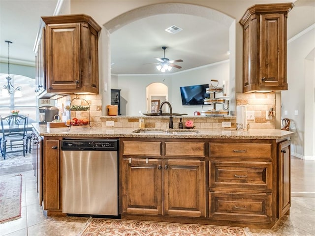 kitchen featuring ceiling fan, ornamental molding, arched walkways, a sink, and stainless steel dishwasher