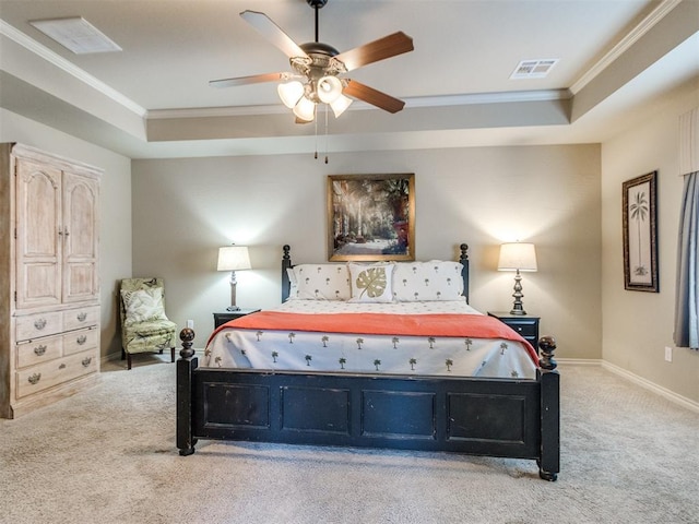 bedroom with crown molding, carpet, and a raised ceiling
