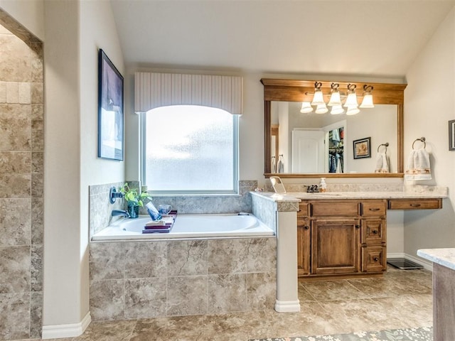 full bath featuring vanity and a garden tub