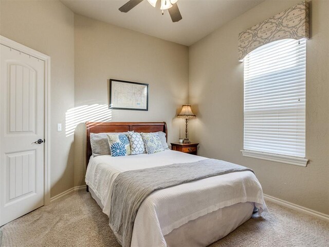 bedroom featuring baseboards, carpet flooring, and a ceiling fan
