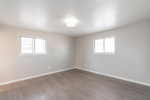 spare room featuring dark hardwood / wood-style floors