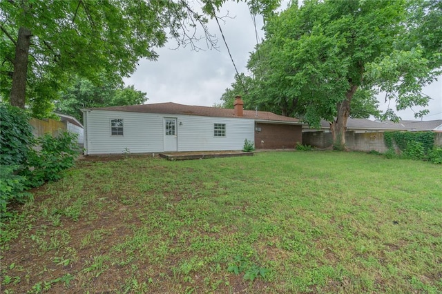 3000 N Viewpoint Dr, Midwest City, OK 73110 - rear view of house featuring a chimney and a wooden deck