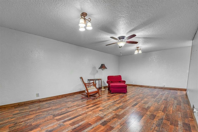 sitting room featuring dark hardwood / wood-style floors, a textured ceiling, and ceiling fan