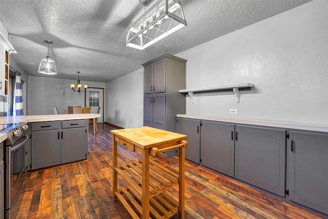 kitchen featuring gray cabinets, hanging light fixtures, electric range, and dark hardwood / wood-style flooring