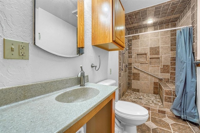 bathroom featuring walk in shower, vanity, and toilet