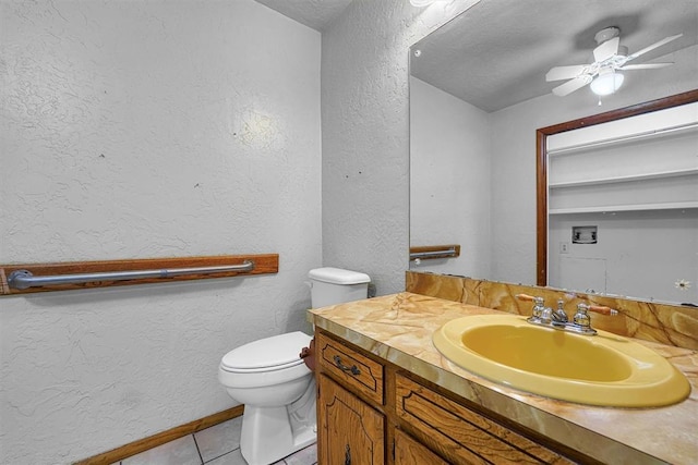 bathroom featuring vanity, tile patterned floors, ceiling fan, and toilet