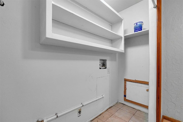 washroom featuring washer hookup, light tile patterned floors, hookup for a gas dryer, and hookup for an electric dryer