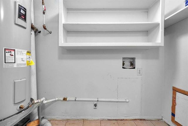 laundry area featuring washer hookup, light tile patterned floors, water heater, and electric dryer hookup